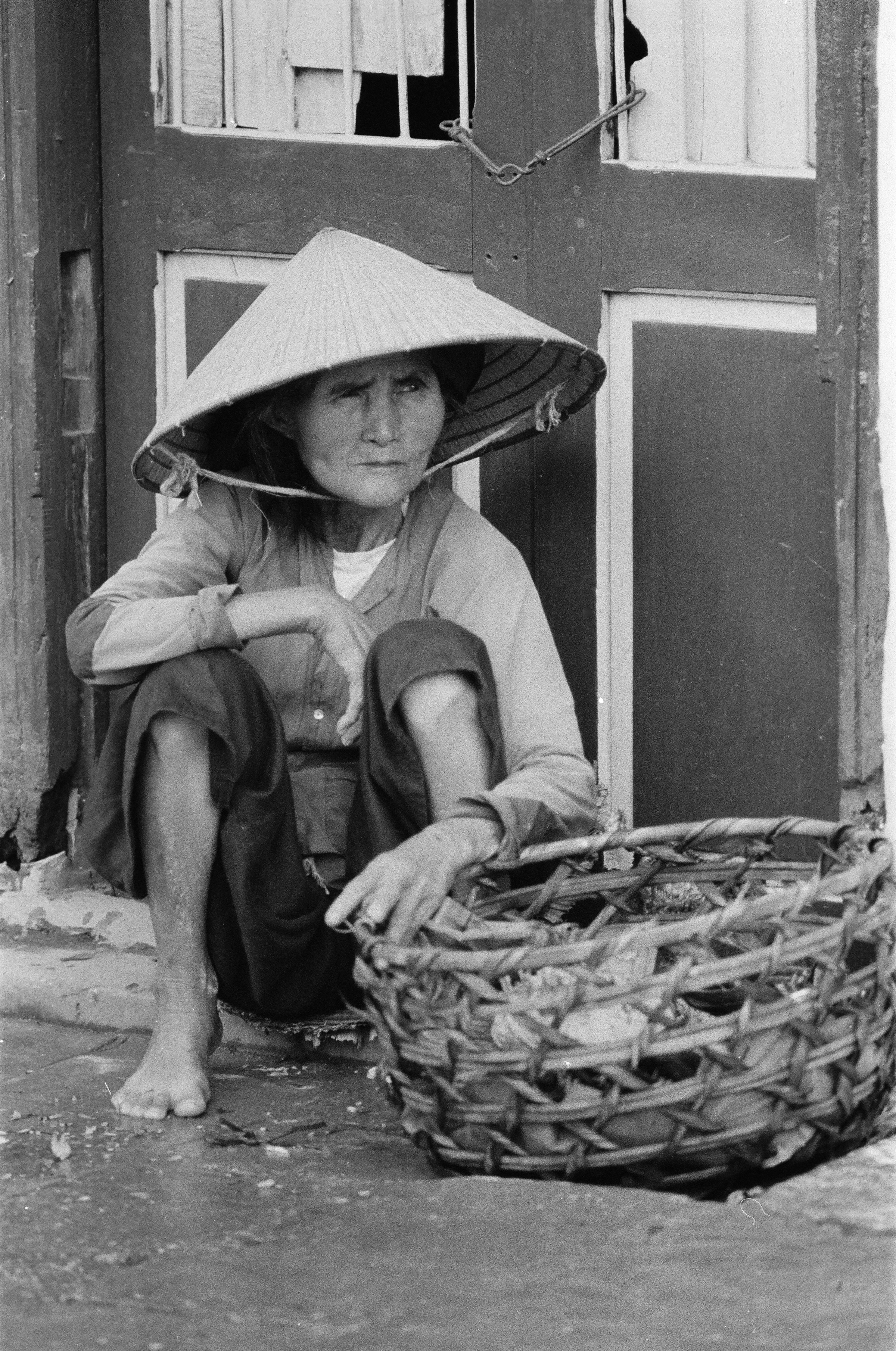 A street vendor selling vegetables in the “outside” market.